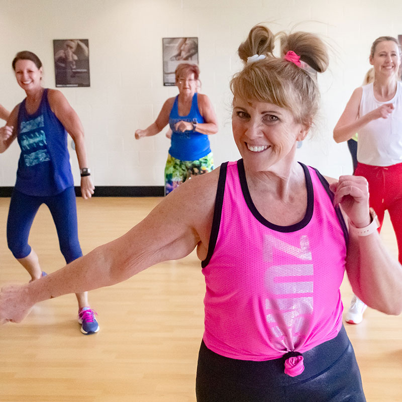 A Group of Women Smiling While Doing Zumba | Group Fitness Classes | The Salvation Army Kroc Center