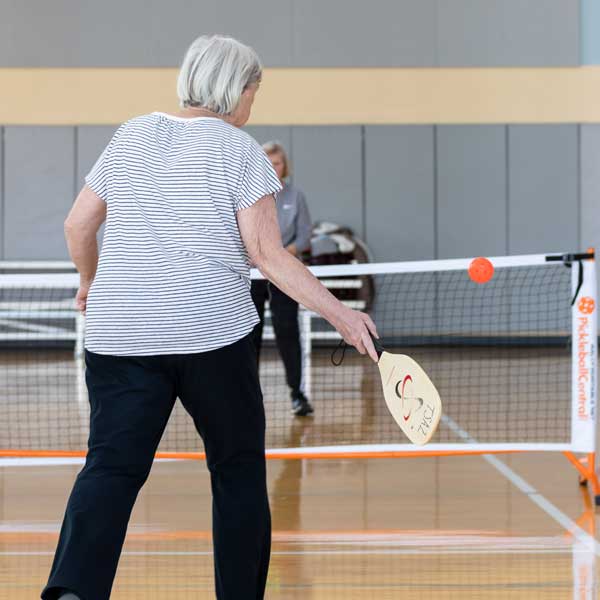 Old woman playing Pickleball