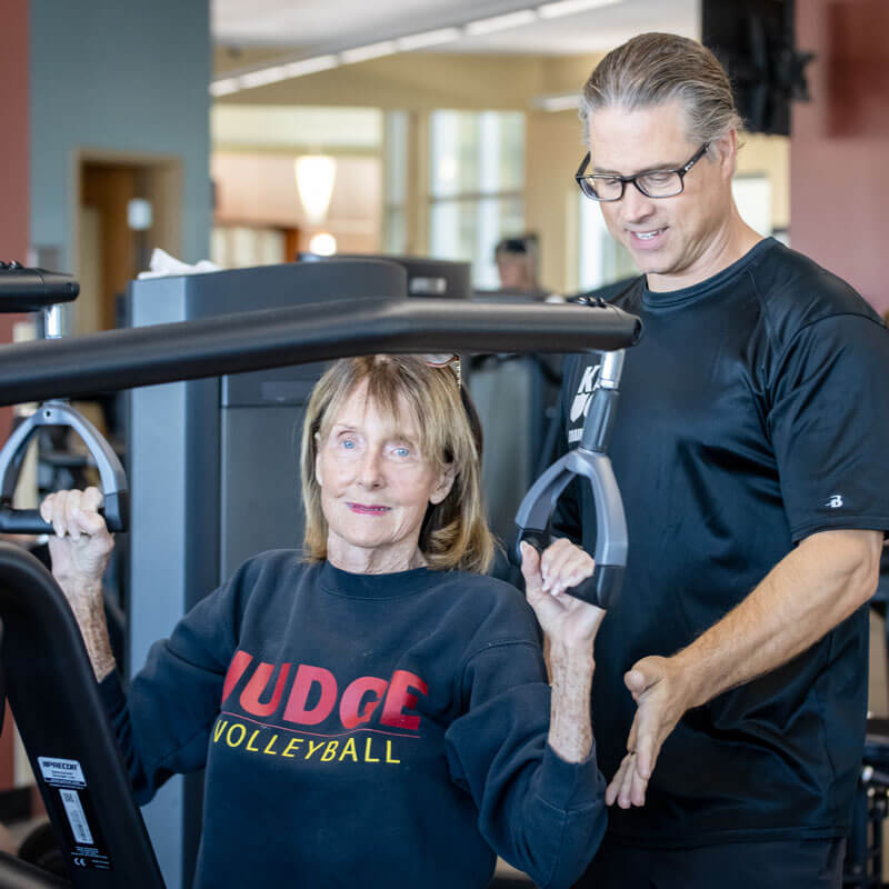 Personal Training helping a woman use proper form during exercising.