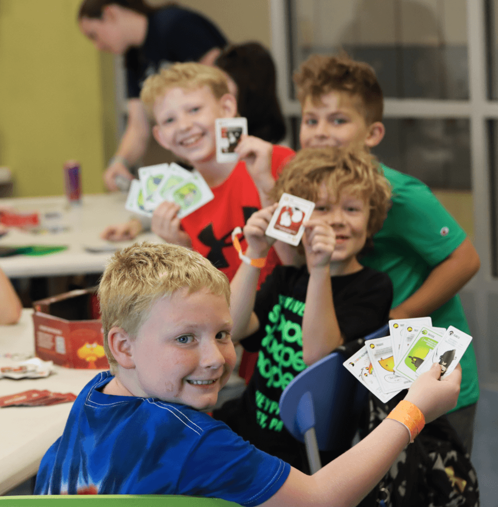 Kids playing a card game.